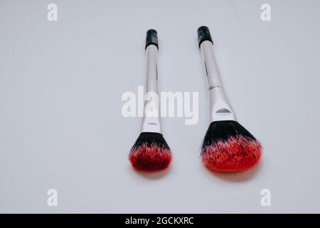 Table makeup brushes of different sizes on the white table Stock Photo