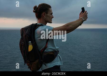 Anonymous astonished ethnic female with open mouth exploring virtual reality in headset on black background Stock Photo