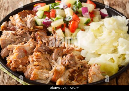Hawaiian Slow cooked Kalua pork served with cabbage and salad close-up on a plate on the table. horizontal Stock Photo