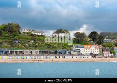 Lyme Regis Dorset, view of Lyme Regis beach with the Langmoor and Lister Gardens rising behind Marine Parade, England, UK