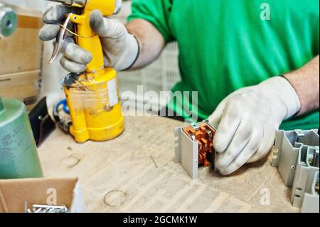 Man worker hold screwdriver machine and use it. Stock Photo