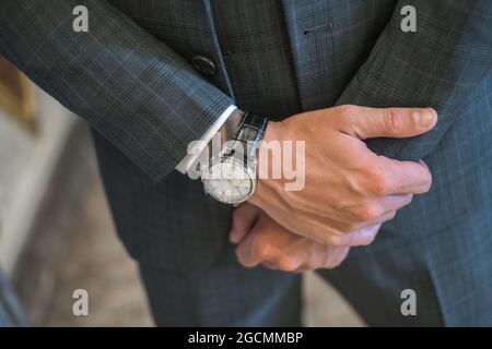 Crossed man's hands, watches with black leather watch strap. High quality photo Stock Photo