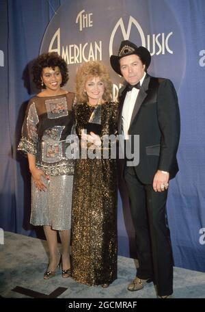 Deniece Williams, Barbara Mandrell and Mickey Gilley at the 10th Annual American Music Awards at Shrine Auditorium in Los Angeles, California January 17, 1983 Credit: Ralph Dominguez/MediaPunch Stock Photo