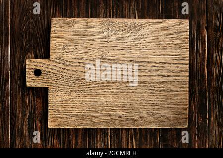kitchen desk cooking mockup. empty vintage wooden cutting board on rustic wooden table top view Stock Photo