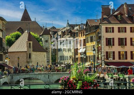 Tourists visit the old town of Annecy with its typical houses and bridges that join the two banks of the Thiou river.Annecy, Savoie department, France Stock Photo