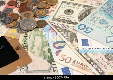 close up image of credit card, coins and banknotes of different currencies Stock Photo