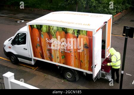 London, UK. 09th Aug, 2021. A Sainsbury's delivery driver prepares to delivery an order to a customer in London. Credit: SOPA Images Limited/Alamy Live News Stock Photo