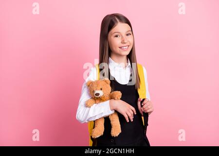 Photo of happy positive cheerful happy small girl hold hands teddy bear isolated on pastel pink color background Stock Photo