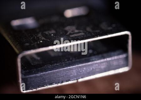 Macro shot of a portable USB head part on a black reflective surface Stock Photo