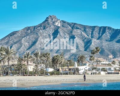 Puerto Banus, Marbella, Spain- July 21, 2020. Puerto Banus beach with blue sky and the shell behind. La Concha is the most famous mountain in Marbella Stock Photo