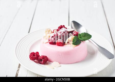 Pink panna cotta dessert with fresh raspberries. Stock Photo