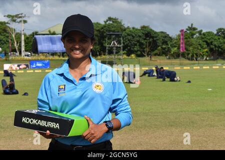 Portrait of a Sri Lanka female umpire at a cricket match at the Army Ordinance cricket grounds, Dombagoda. Females who have been involved with cricket as players are taking up umpiring and scoring to be involved with the game. Sri Lanka.
