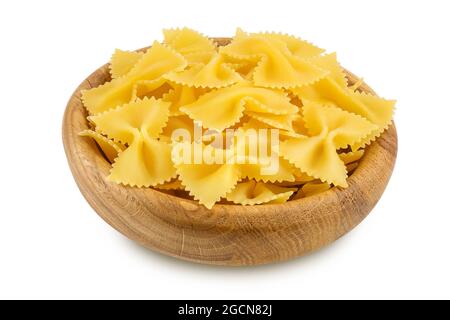 Bow tie pasta in wooden bowl isolated on white background with clipping path and full depth of field. Stock Photo