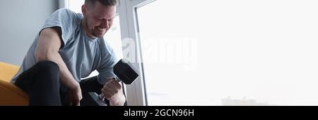 Man does exercises with dumbbells for biceps Stock Photo