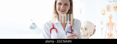 Smiling portrait medic holds human skull closeup Stock Photo