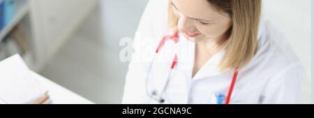 Doctor is typing on keyboard at desktop Stock Photo