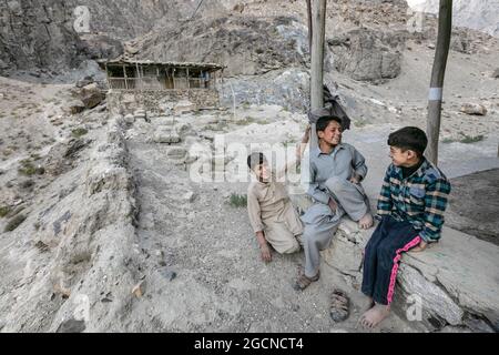 Gilgit-Baltistan, Pakistan - June 2021: Boys in mountain village near the Afghanistan boarder  Stock Photo