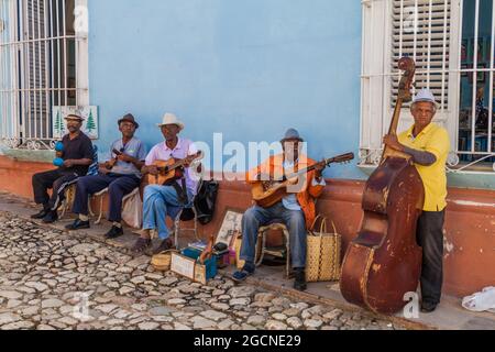 TRINIDAD, CUBA - FEB 8, 2016: Group of local musicians plays on a street in the center of Trinidad, Cuba. Stock Photo