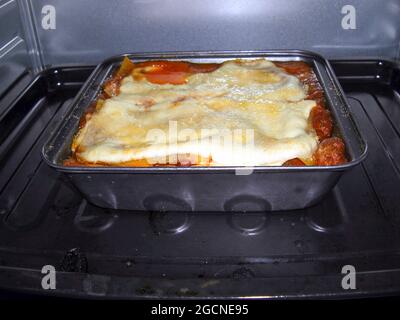 Fresh Lasagne is baking in the oven 1.11.2017 Stock Photo