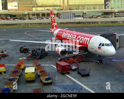 Air Asia Airbus A320-216 is parking at the gate at the international airport in Manila on the Philippines 7.12.2018