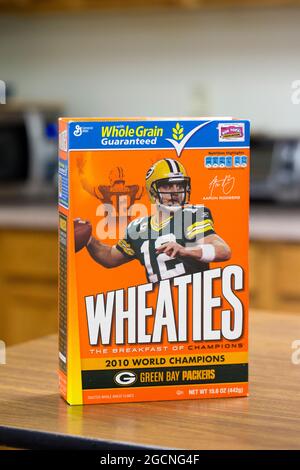 A Wheaties breakfast cereal box with photos of Green Bay Packers quarterback Aaron Rodgers sitting on a kitchen counter. Stock Photo