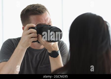 Male photographer photographing portrait of female model Stock Photo