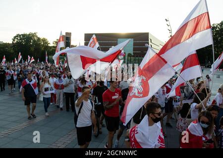 Wroclaw, Poland. 09th Aug, 2021. Demonstrators march while holding Belarusian flags during the demonstration.Demonstrators take part in a solidarity March with Belarus in Wroclaw, on the one-year anniversary of Belarus's alleged fraudulent presidential election. Credit: SOPA Images Limited/Alamy Live News Stock Photo