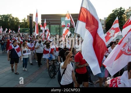 Wroclaw, Poland. 09th Aug, 2021. Demonstrators march while holding Belarusian flags during the demonstration.Demonstrators take part in a solidarity March with Belarus in Wroclaw, on the one-year anniversary of Belarus's alleged fraudulent presidential election. (Photo by Lidia Mukhamadeeva/SOPA Images/Sipa USA) Credit: Sipa USA/Alamy Live News Stock Photo