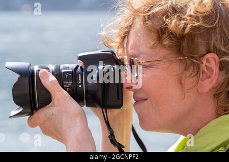 woman taking photos, Lake Maggiore, Piedmont, Italy Stock Photo