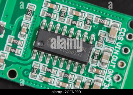 Macro close-up shot of small body motion sensor circuit board pcb. IC chip RCWL-0516 is a transmission signal processing control chip.