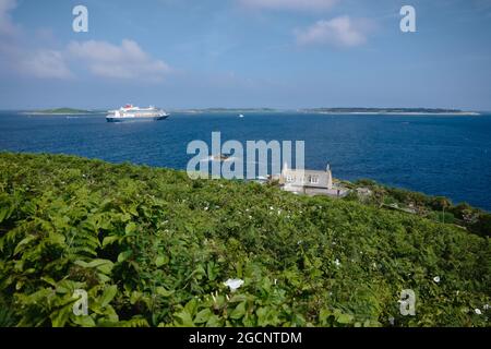 A cruise ship off the coast of St Mary's island, viewed from Garrison Hill, Isles of Scilly, Cornwall, England, UK, July 2021 Stock Photo