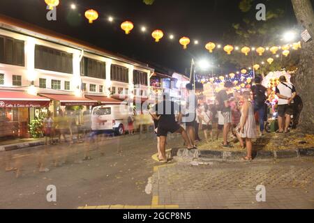 GEORGETOWN, MALAYSIA - Feb 02, 2020: The nightlife in the streets of Georgetown in Malaysia with blurry people in motion Stock Photo