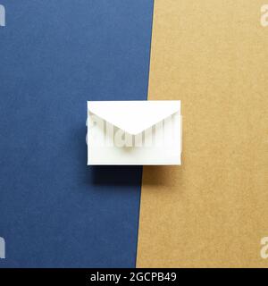 White envelope on blue and brown background. top view, copy space Stock Photo