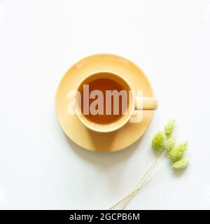 Cup of tea with dry flower on white background. top view, copy space Stock Photo