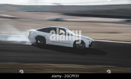VicDrift Round 2: White Nissan 180SX drifts around Calder Park entertaining the crowd during a break in competition. Stock Photo