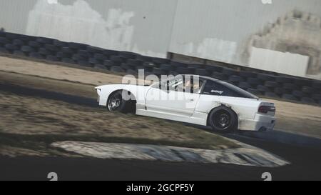 VicDrift Round 2: White Nissan 180SX drifts around Calder Park entertaining the crowd during a break in competition. Stock Photo