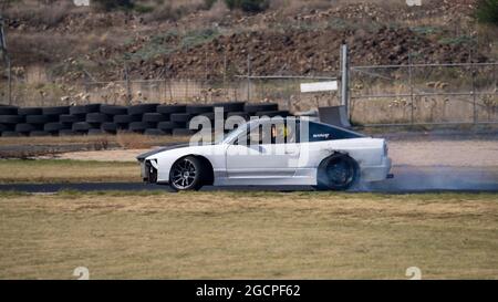 VicDrift Round 2: White Nissan 180SX drifts around Calder Park entertaining the crowd during a break in competition. Stock Photo