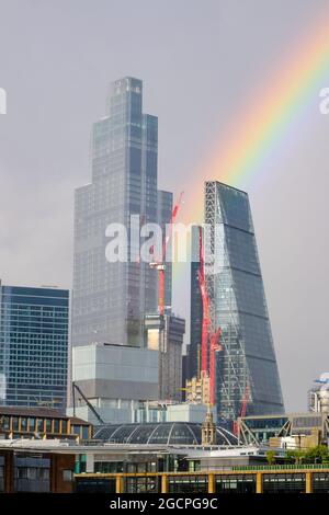 A rainbow is seen after a heavy rain shower over the City of London, with 22 Bishopsgate and the Scalpel most prominently seen. Stock Photo