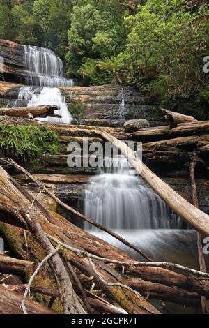 a large waterfall over some water in tasmania Stock Photo