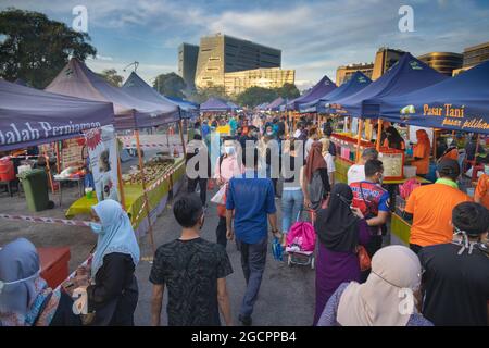 The fresh market in Putrajaya, near the capital Kuala Lumpur, is busy. Face masks are compulsory during the Covid-19 restrictions. People carry their Stock Photo