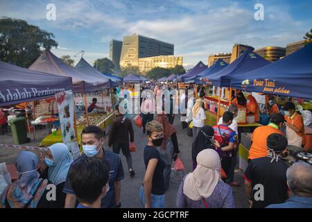 The fresh market in Putrajaya, near the capital Kuala Lumpur, is busy. Face masks are compulsory during the Covid-19 restrictions. People carry their Stock Photo