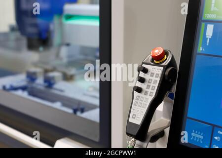 Pendant remote control of manufacturing machine. Selective focus. Stock Photo