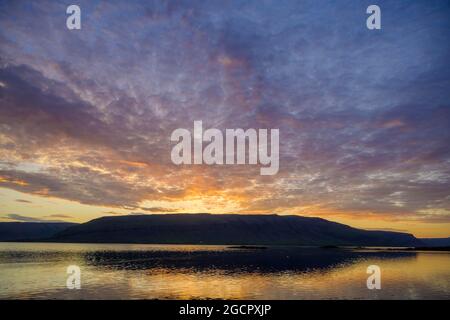 Sunset over the fjord at an old jetty, Reykholahreppur, Vestfiroir, Iceland Stock Photo