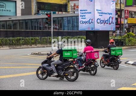 Kuala Lumpur, Malaysia - October 04, 2020: Grab food delivery rider on the motorbike.  Food delivery by motorcycle determine everyday life during the Stock Photo