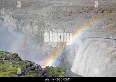 Rainbow in front of waterfall, stone desert in the background, Dettifoss, Joeulsa a Fjoellum, Iceland Stock Photo