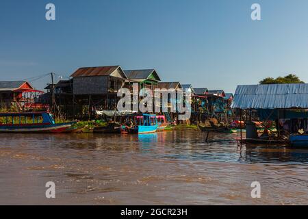 Kampong Phluk Floating Village on Tonle Sap lake near Siem Reap, Cambodia during sunset. The Stilt houses of the floating town. Exotic places South Ea Stock Photo