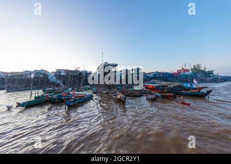 Kampong Phluk Floating Village on Tonle Sap lake near Siem Reap, Cambodia during sunset. The Stilt houses of the floating town. Exotic places South Ea Stock Photo