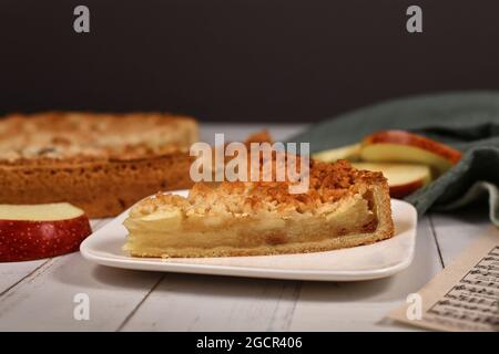Slice of traditional European apple pie with topping crumbles called Streusel on plate Stock Photo