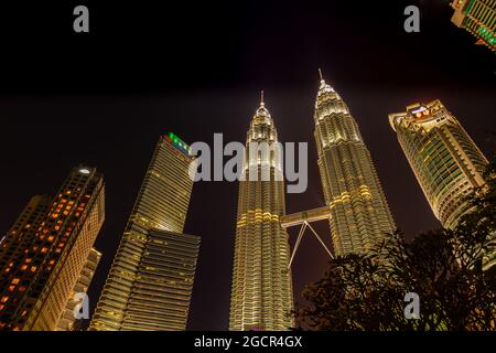 Kuala Lumpur, Malaysia - November 28, 2020: At night at the Petronas tower or twin towers in the heart of the South East Asia metropolis. Suria KL tow