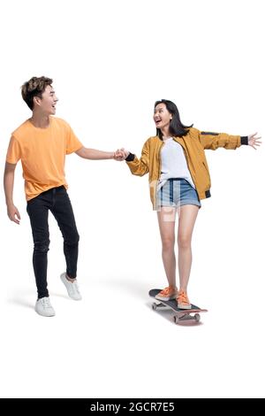 Happy young couple enjoying skateboarding Stock Photo